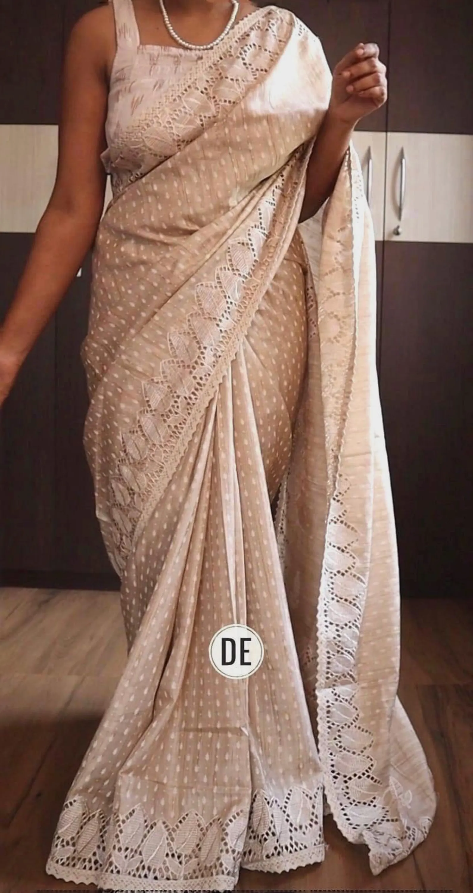 Beige embroidered saree with intricate threadwork